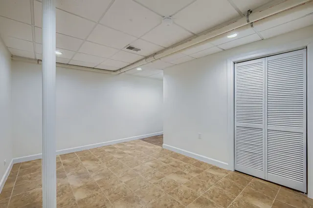 a bathroom with a granite countertop sink mirror vanity and toilet