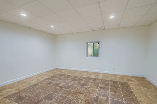 a bedroom with a bed and a black white checkered floor