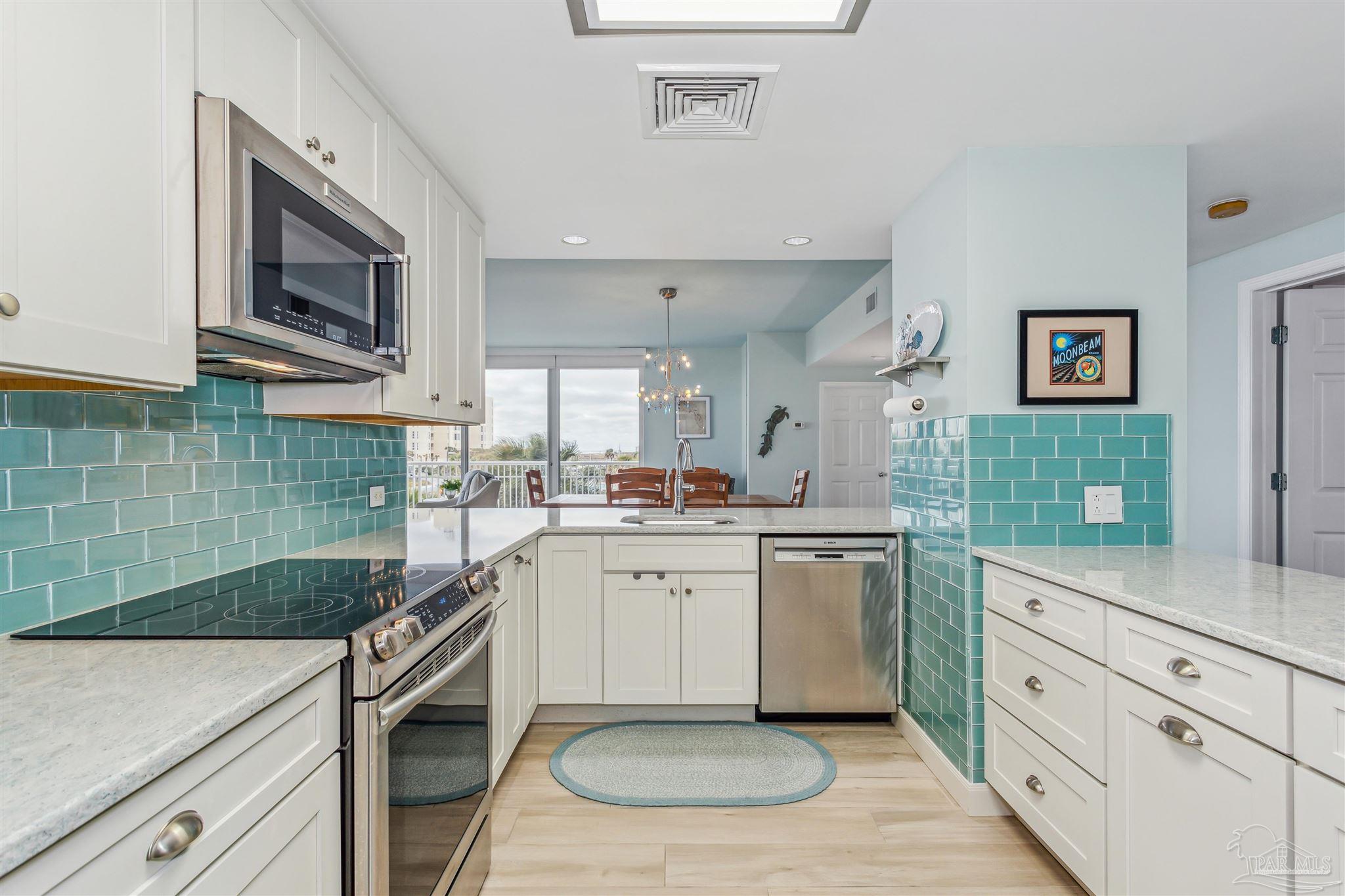 800 Fort Pickens Road, Unit 204 Pensacola Beach, FL 32561 - Photo 4 of 45 a kitchen with a sink stove and microwave