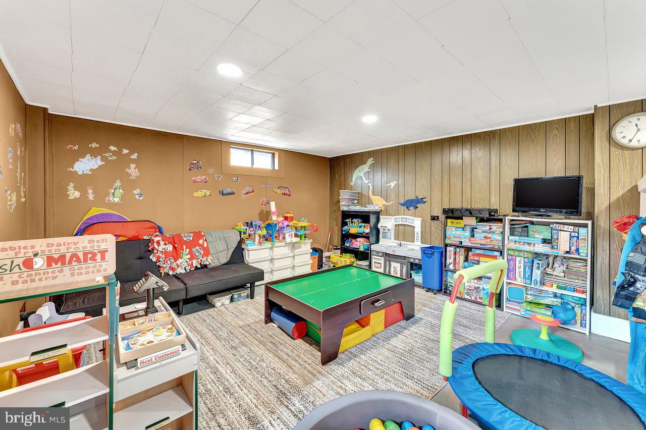 504 Jefferson Street Riverside, NJ 08075 - Photo 20 of 25 a living room with lots of furniture and a flat screen tv