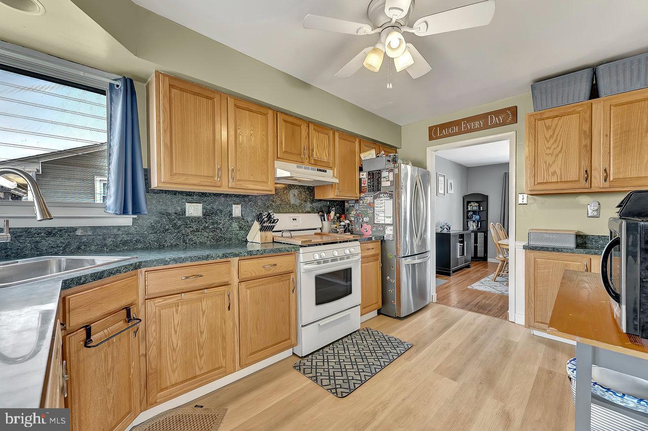 504 Jefferson Street Riverside, NJ 08075 - Photo 10 of 25 a kitchen with stainless steel appliances granite countertop a refrigerator a stove top oven a sink and dishwasher