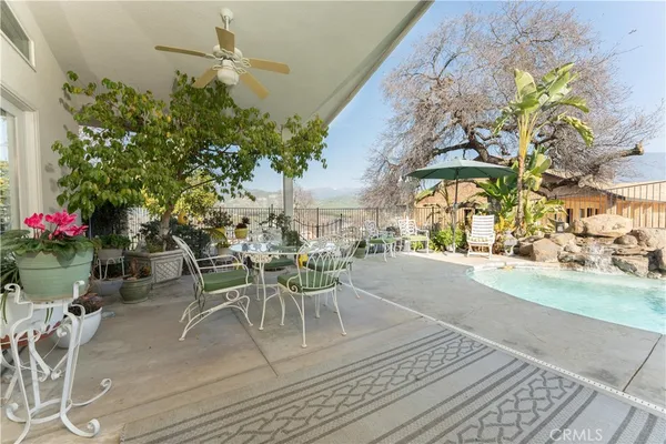 a view of a patio with table and chairs and potted plants