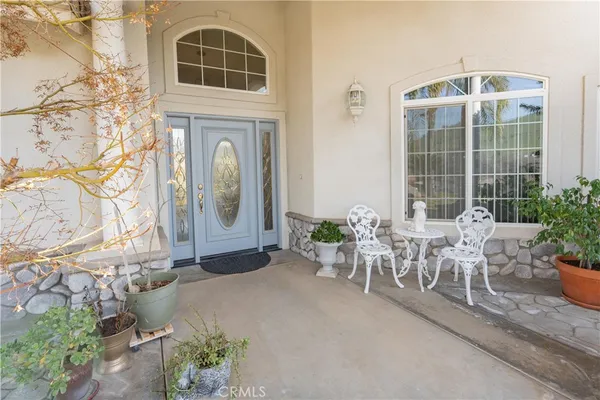 a front view of a house with outdoor seating and plants