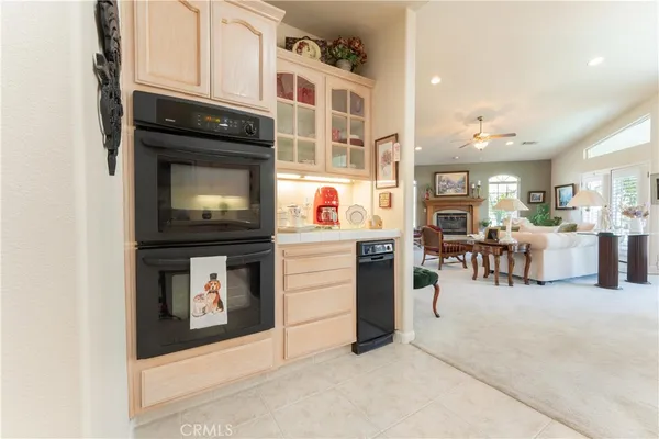 a kitchen with stainless steel appliances granite countertop a sink and a refrigerator