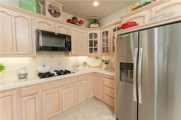 a bathroom with a granite countertop toilet a sink and a mirror