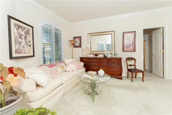 a spacious bedroom with a bed and ceiling fan