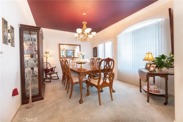 a view of a dining room with furniture and chandelier