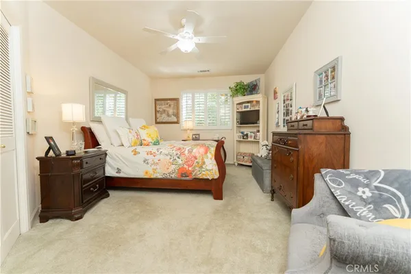 a bed sitting in a bedroom next to a window with a dresser