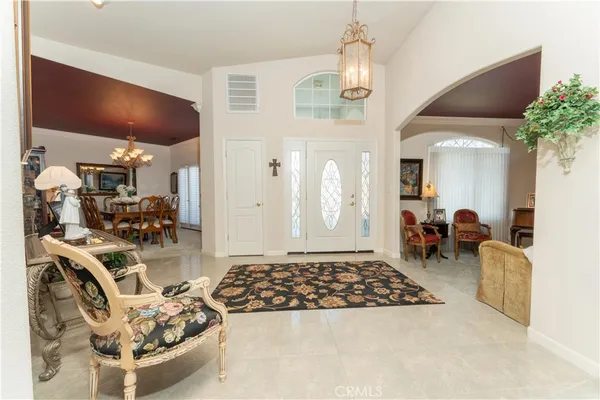 a living room with furniture and a chandelier