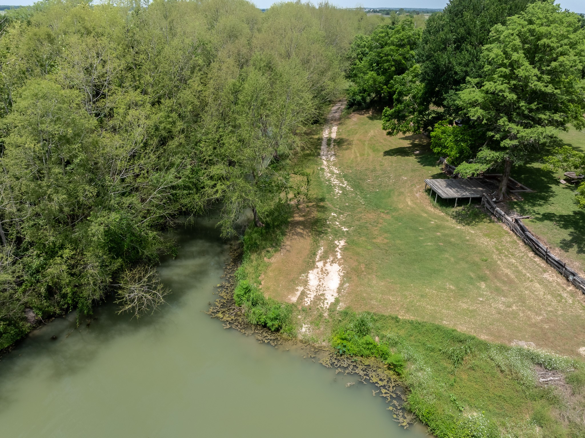 2091 Goodwin Road Gonzales, TX 78629 - Photo 19 of 23 a view of a lake with a forest
