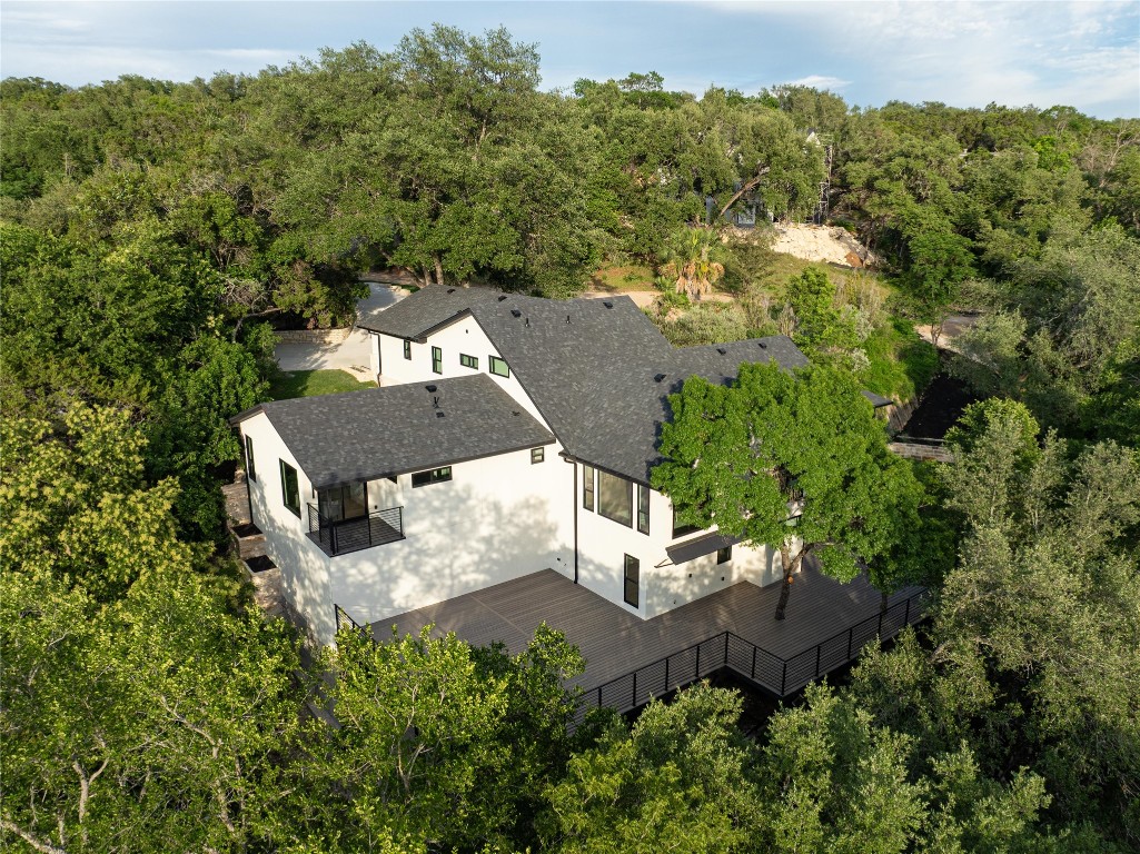 an aerial view of a house with a yard