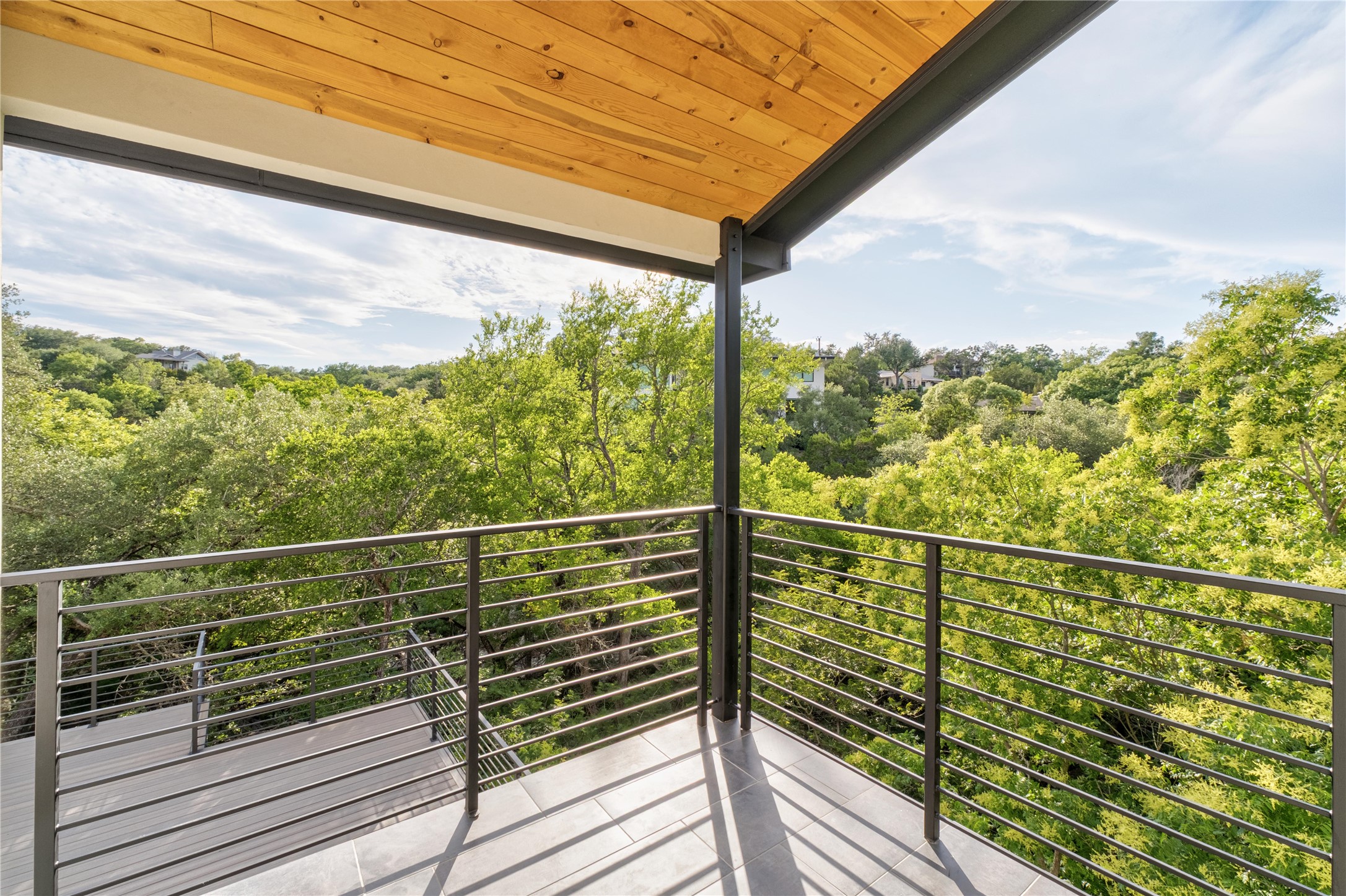 620 Bermuda Street Lakeway, TX 78734 - Photo 14 of 36 Balcony off the Primary bedroom featuring a view of trees and stream. Perfect to enjoy your morning coffee