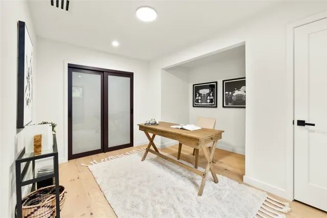 a bedroom with a bed a window and wall