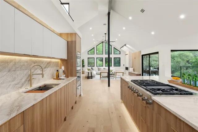 a kitchen with stainless steel appliances granite countertop a stove and a sink