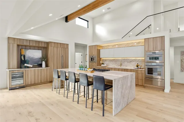 a view of a kitchen with a sink and dishwasher with wooden floor