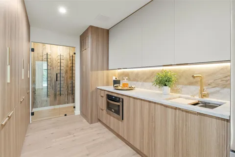 a bedroom with a large bed a chandelier and windows