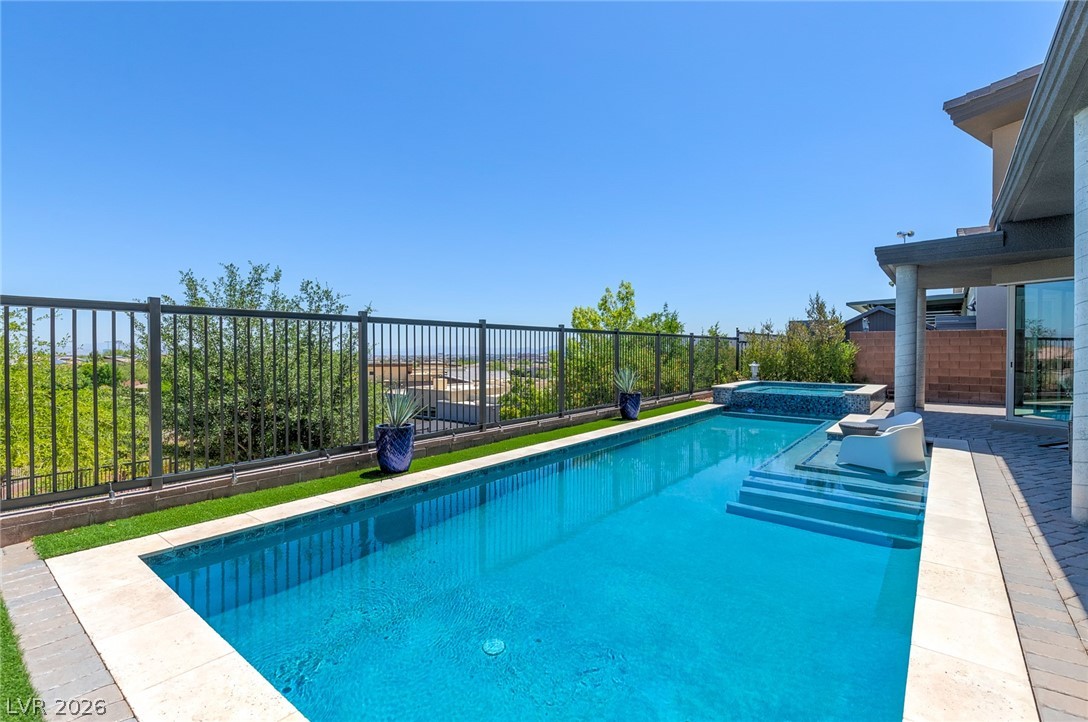 6014 Willow Ridge Court Las Vegas, NV 89135 - Photo 66 of 99 An inviting backyard oasis features a glistening pool and a relaxing spa, perfect for outdoor enjoyment.