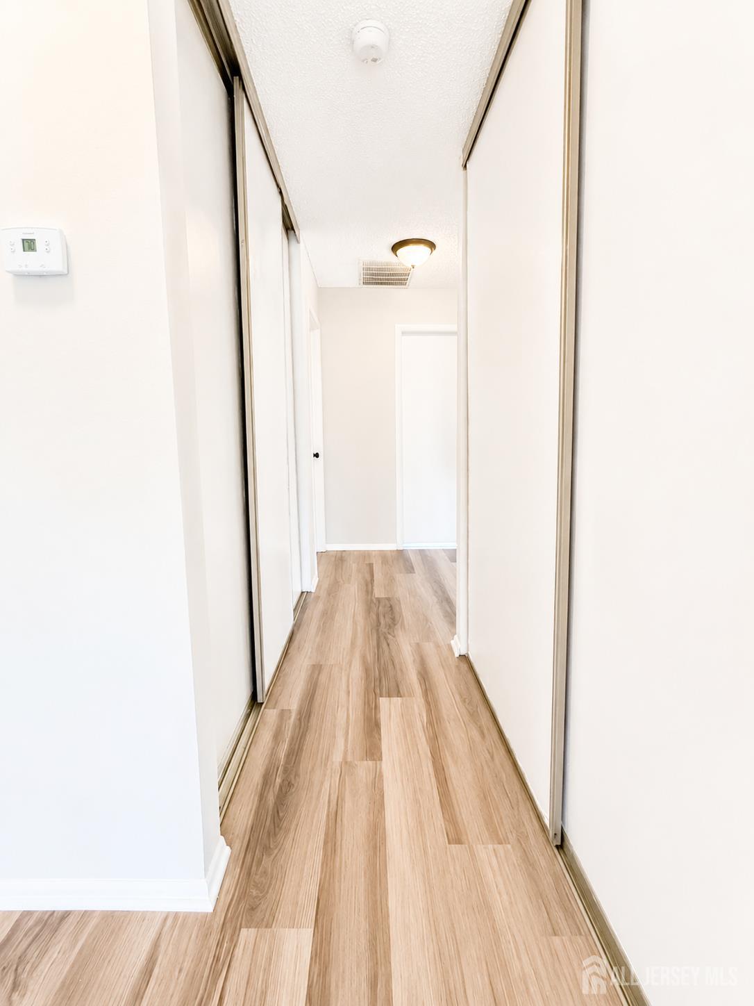621 A Deal Road Monroe Township, NJ 08831 - Photo 14 of 27 a view of a hallway with wooden floor