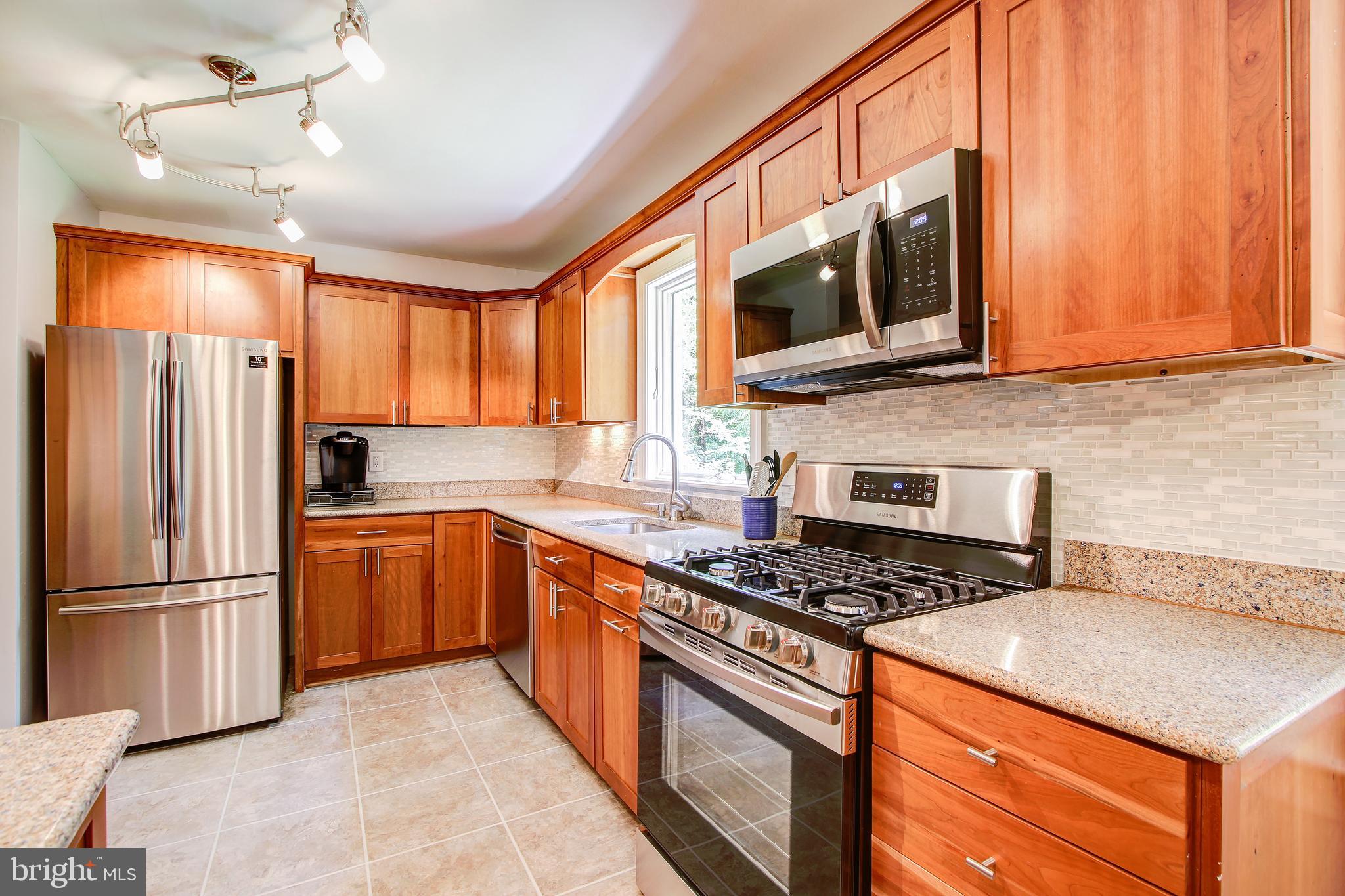 8403 Riverside Road Alexandria, VA 22308 - Photo 14 of 52 Kitchen - Granite Countertops and Tiled Backsplash