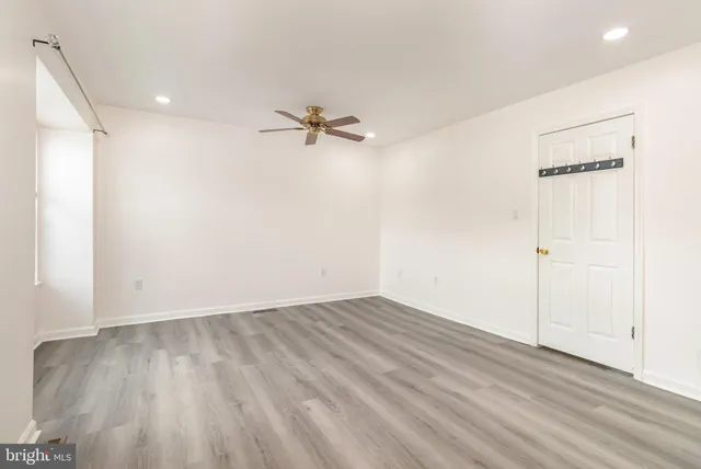 wooden floor in an empty room with a window