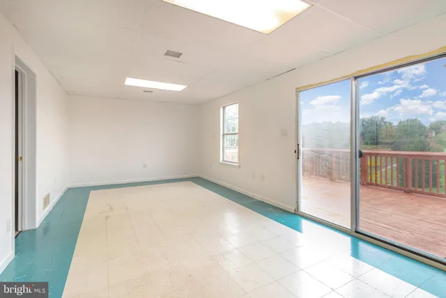 a view of an empty room and glass door