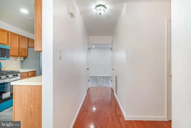 a view of a hallway with wooden floor