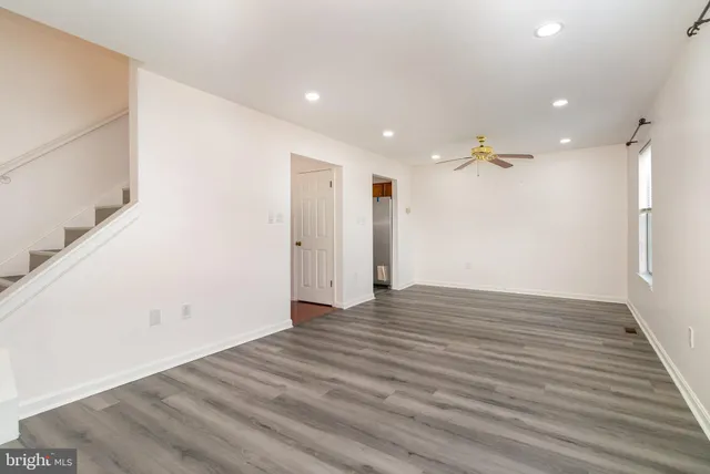 a view of an empty room with wooden floor