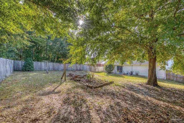 a view of a house with a backyard and a garage