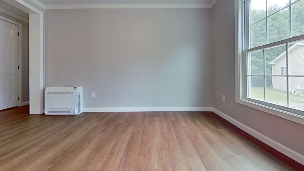 4 Juniper Circle Rockland, MA 02370 - Photo 4 of 11 a view of an empty room with wooden floor and a window