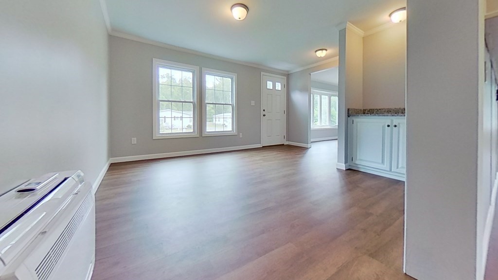 4 Juniper Circle Rockland, MA 02370 - Photo 5 of 11 an empty room with wooden floor and windows