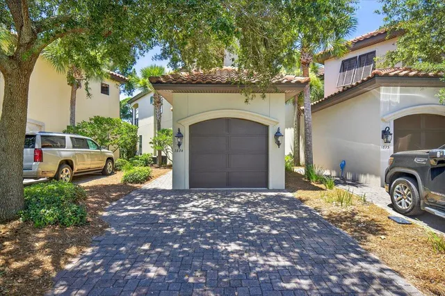 a front view of a house with a garden and parking space
