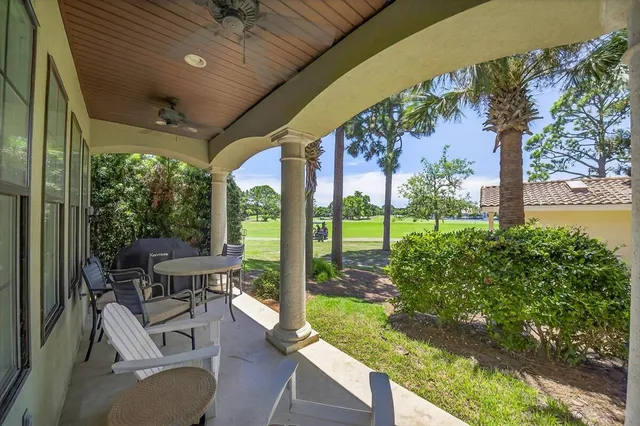 a view of a patio with table and chairs potted plants with large tree