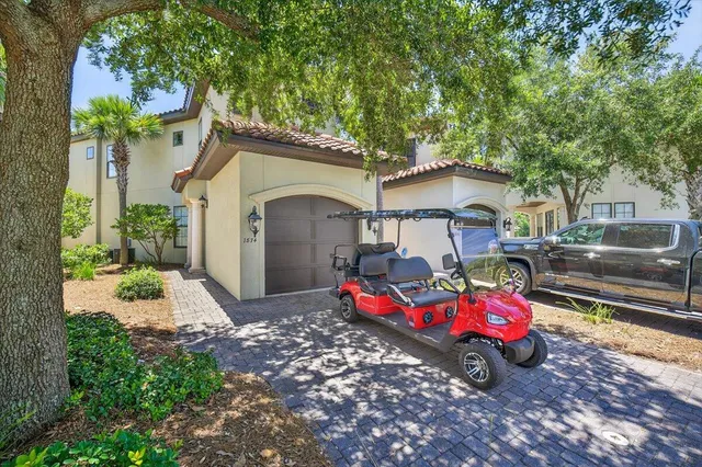 a front view of a house with a garden and parking space
