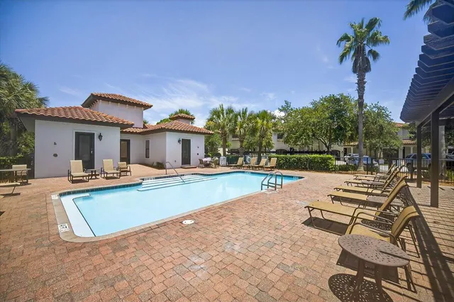 a view of a house with swimming pool and sitting area