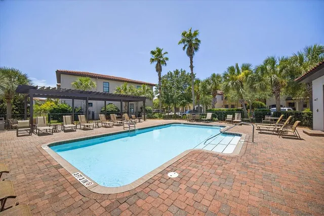 a view of a swimming pool with outdoor seating