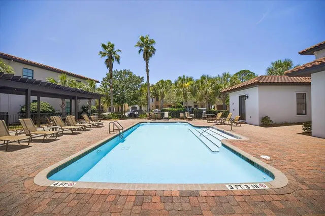 a view of a house with swimming pool and sitting area
