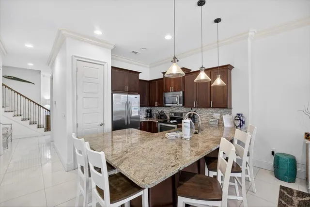 a dining room filled with furniture and wooden floor