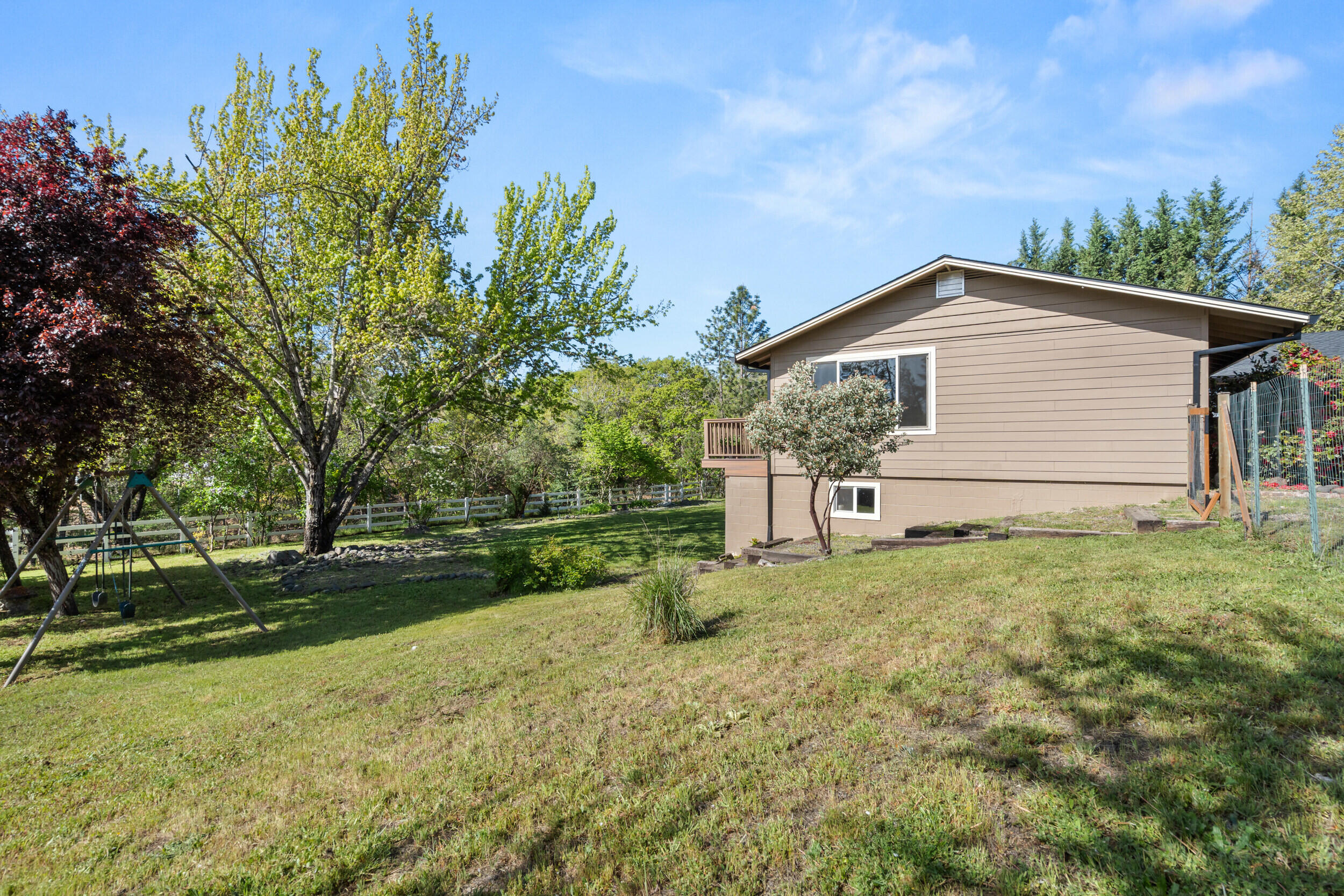 3583 Ross Lane Central Point, OR 97502 - Photo 35 of 52 a backyard of a house with plants and large tree