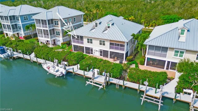 a aerial view of a house with a yard patio and garage