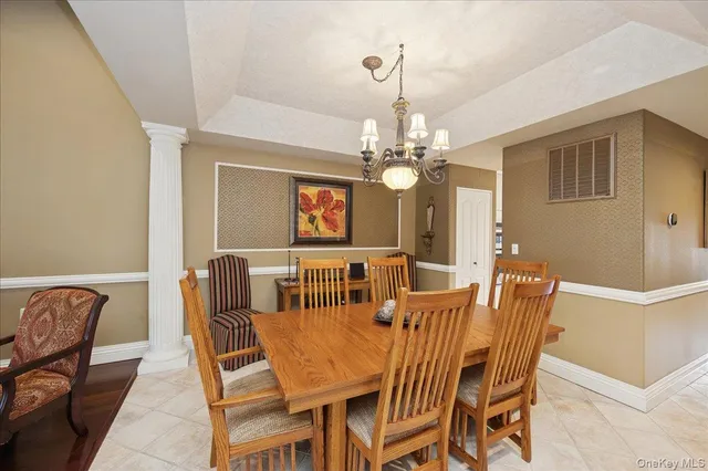 a view of a dining room with furniture and chandelier
