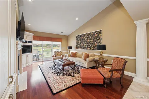 a living room with furniture rug and wooden floor