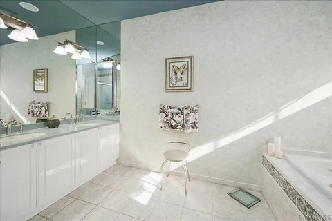 a bathroom with a double vanity sink and a mirror