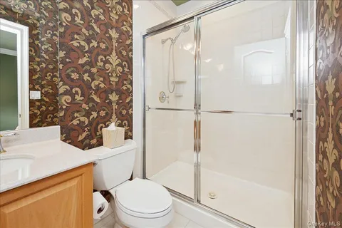a white toilet sitting next to a bathroom sink