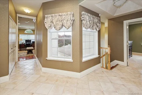 a view of a hallway with dining area and chandelier