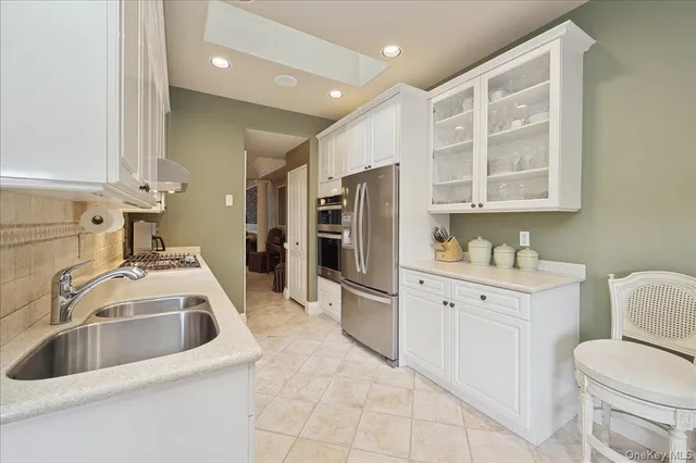 a kitchen with a sink cabinets and appliances