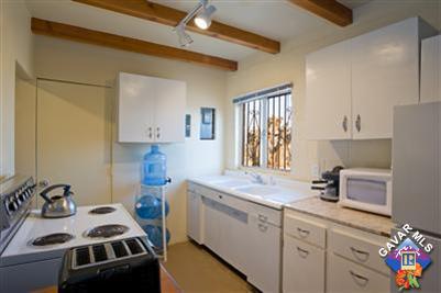7671 Quartz Road Mojave, CA 93501 - Photo 3 of 10 a kitchen that has a sink a stove and cabinets