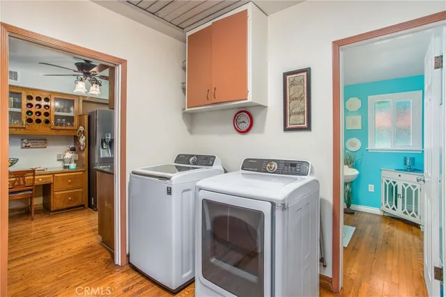 a view of washer and dryer with kitchen in the background