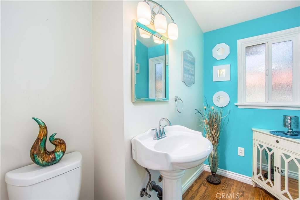 3095 Pepper Tree Lane San Bernardino, CA 92404 - Photo 13 of 29 a bathroom with a sink mirror and toilet