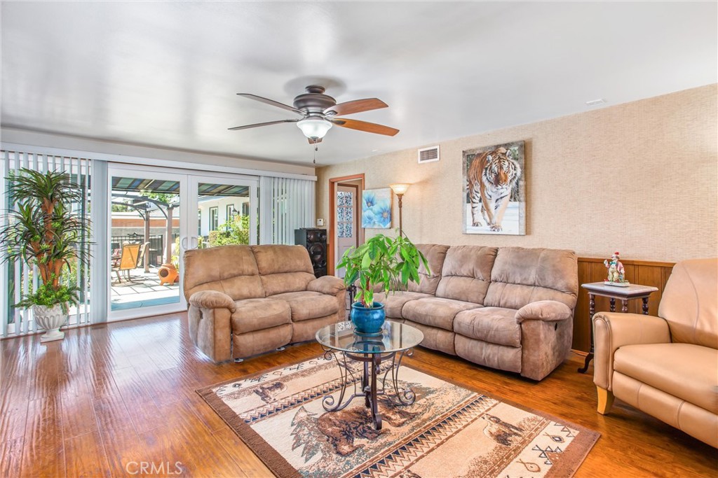 3095 Pepper Tree Lane San Bernardino, CA 92404 - Photo 14 of 29 a living room with furniture wooden floor and a large window
