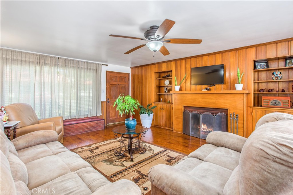 3095 Pepper Tree Lane San Bernardino, CA 92404 - Photo 15 of 29 a living room with furniture a fireplace and a flat screen tv